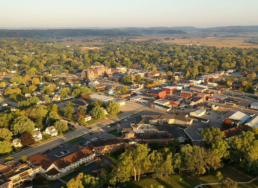 Lone Jack, MO - Aerial View of Homes and Businesses Surrounded by Green Tress in Lone Jack Missouri on a Sunny Day